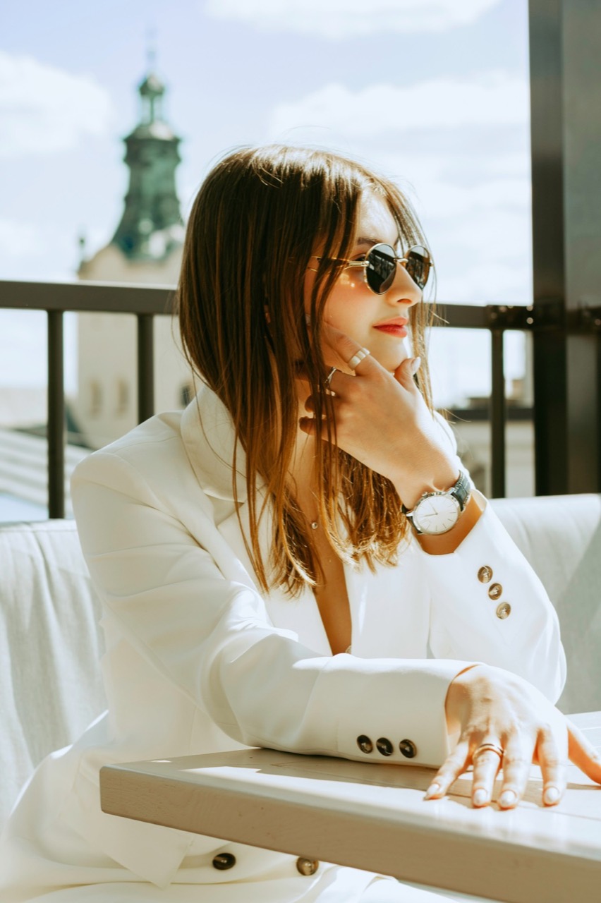 A woman in a white suit on a rooftop in Lviv